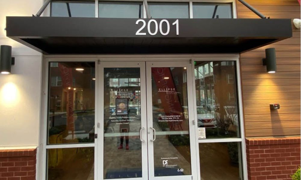 Building entrance with 2001 on the canopy, featuring glass doors and a modern exterior.